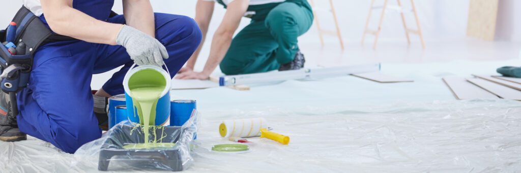 painter pouring green paint